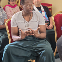 people of colour sat in a Buddhist discussion event